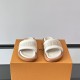 Frontal view of white ecru L slides Frontal perspective of the white ecru L slides highlighting the textured branded strap design
