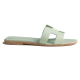 Hermes Oran Flat Sandals In Light Green - Side Profile Side profile view of light green flat sandals featuring a signature cutout strap