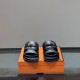 Hermes Jackson Leather Sandals In Black - Front Angle in black and silver Frontal view of the Hermes Jackson Leather Sandals In Black highlighting metallic closure details in black and silver