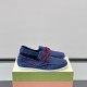 Side profile view of Marni Men's Blue Nubuck Boat Shoes displayed on a shoe box in blue and red