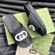 Gucci Men's Interlocking G Slide Sandals In Black Angled View in black and white Gucci Men's Interlocking G Slide Sandals In Black angled arrangement over patterned green boxes in black and white