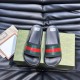 Gucci Slide Sandals Pair Front View in Black in black and red Front-facing pair view of black Gucci rubber slide sandals displaying textured footbeds and striped straps