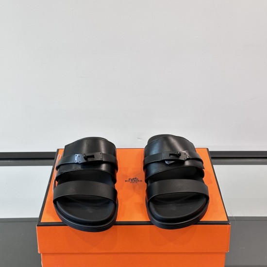 Hermes Jackson Sandals In Black Front View Hermes Jackson Sandals In Black front-facing view on top of packaging