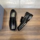 Prada Men's Brushed Leather Loafers In Black Top and Angled View Prada men's black brushed leather loafers shown from top-down and angled perspective