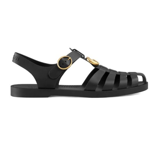 Gucci Black Rubber Sandals Side Profile in black and gold Studio profile view of Gucci black rubber sandals with gold buckle