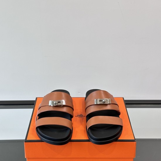 Hermes brown leather slide sandals front angle view in brown and silver Hermes brown leather slide sandals front angle view displaying silver clasps