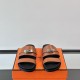 Hermes brown leather slide sandals front angle view in brown and silver Hermes brown leather slide sandals front angle view displaying silver clasps