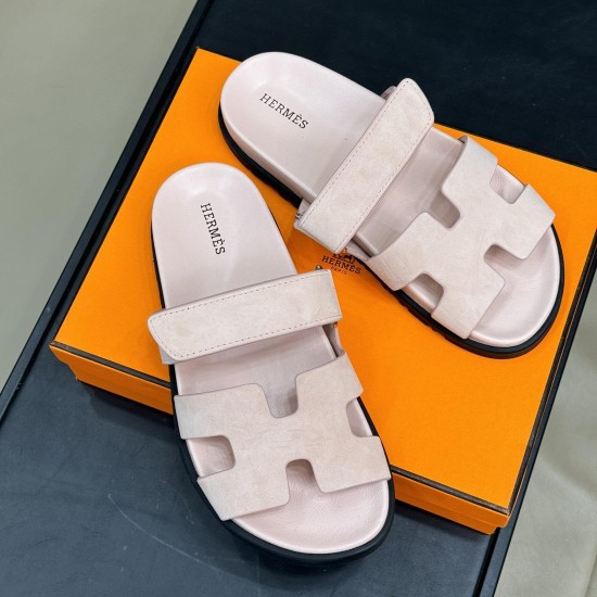 Hermes Chypre Sandals In Light Pink Overhead View Top-down overhead view of Hermes Chypre Sandals In Light Pink resting on an orange box, highlighting the H-cutout straps