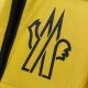 Moncler Men's Chest Logo Graphic Detail Close-up of Moncler Men's logo graphic print on yellow coat fabric