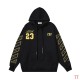 Front view of Off-White black hooded sweatshirt with gold Abloh 23 chest print and printed sleeves