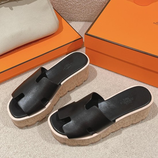 Hermes Eze Black Platform Sandals Pair Front View Front three-quarter angle of the pair of black sandals resting beside orange brand boxes
