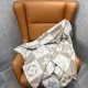 L Women's Checkmate Blanket Brown Motif Scarf draped over a chair showing motif details in beige and brown