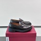 Pair of Ferragamo Men's Black Leather Chunky Sole Loafers resting on a burgundy shoe box seen from the side.