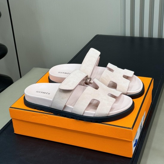 Hermes Chypre Sandals In Light Pink Angled View Angled perspective view of Hermes Chypre Sandals In Light Pink displayed neatly on a branded orange storage box
