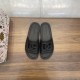 Direct overhead view of both Dolce & Gabbana black rubber slides displaying embossed logo straps