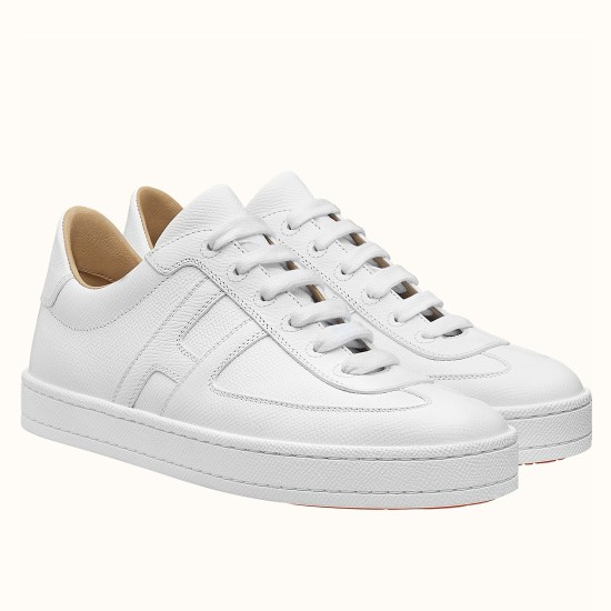 Hermes Boomerang White Grain Leather Trainers Pair View Pair of Hermes Boomerang white grain leather trainers displayed at an angle against a plain background.