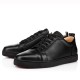 Christian Louboutin Louis Junior Flat Black Leather Trainers Pair Pair of Christian Louboutin Louis Junior Flat black leather low top trainers shown from a three-quarter angle