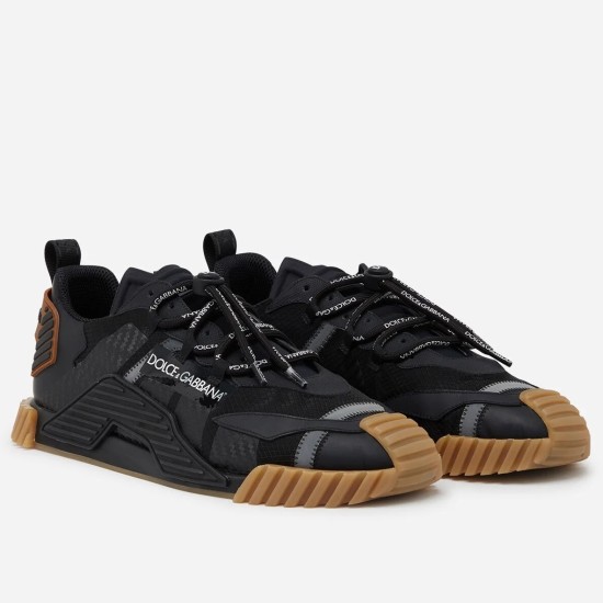 Pair of Dolce & Gabbana black fabric trainers with tan rubber soles angled front view