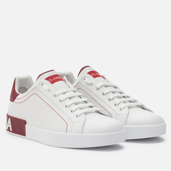 Front elevated view of Dolce & Gabbana Portofino white leather trainers with red accents