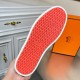 Vibrant orange patterned rubber tread sole on Hermes Boomerang trainer in white and blue