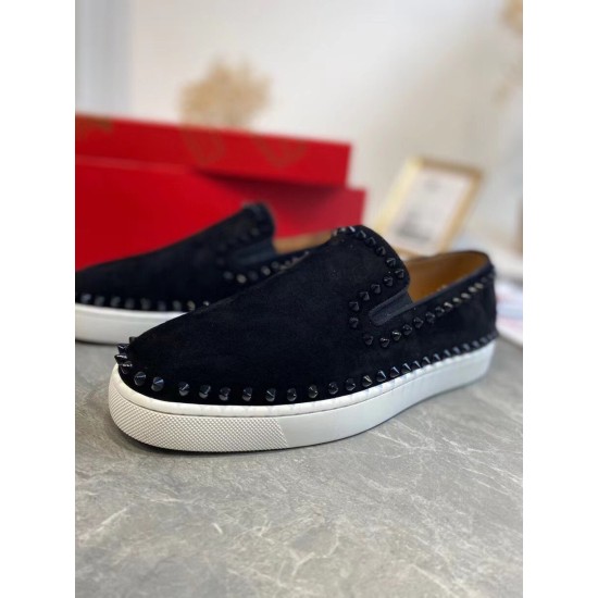 Front angular view of black suede Christian Louboutin Pik Boat Flat trainers showing black spike embellishments in black and white