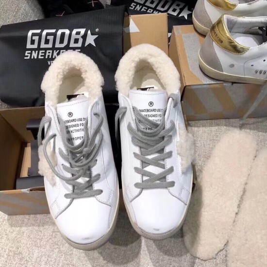 Golden Goose Super-Star White Leather Trainers Top View in white and grey Top-down view of Golden Goose white leather shearling-lined trainers in box in white and grey