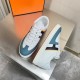 Hermes Boomerang trainers presented together from a top angle in white and blue