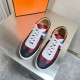 Top-down view of Hermes Boomerang multicolour leather trainers on a metallic surface