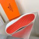 Hermes Boomerang Trainer Orange Rubber Tread Sole View in white Underside view showing the vibrant orange rubber tread pattern sole of the Hermes Boomerang trainer in white