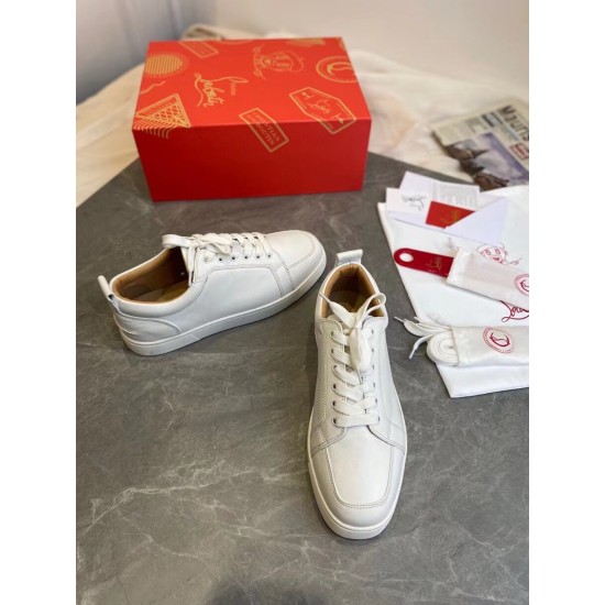 Christian Louboutin Louis Junior Flat White Trainers Set View Overhead layout of Christian Louboutin Louis Junior Flat white trainers with luxury dust bag