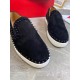 Front close-up of toe caps on black Christian Louboutin Pik Boat Flat suede trainers with black spikes in black and white