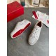 Top-down view of white spiked leather trainers alongside branded accessories in white and silver