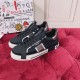 Dolce & Gabbana Custom 2.Zero Elevated View in black and white Angled view of black leather trainers on a plush surface next to branded box in black and white