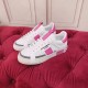 Dolce & Gabbana Custom 2.Zero White And Pink Trainers Pair Pair of white and pink Dolce & Gabbana Custom 2.Zero trainers on red tufted surface