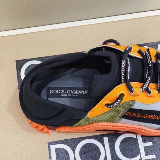 Close-up view of the shoe opening and black branded inner label inside the orange and green trainer