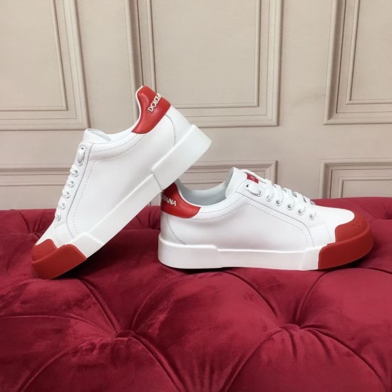 Side view of two white trainers resting against each other showing thick white soles in white and red