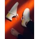 Stylised View of White Leather Portofino Trainers in white and yellow Top-down view of white and yellow leather trainers on bright red carpet background