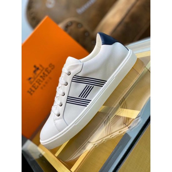 Hermes Avantage Leather Trainers Display View in white and blue Side view of white leather trainer resting beside orange brand box in white and blue