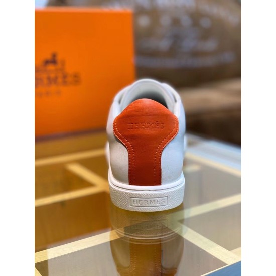 Heel View showing Orange Leather Logo Tab in white and orange Rear close-up view showing orange leather heel tab with embossed logo and white rubber sole