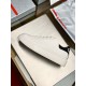 Lateral side view of single Prada Macro white leather trainer on display tray in white and black