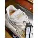 Versace Trigreca Low Top White Trainer Tongue Detail View in white and gold Close-up of tongue, Medusa lace charm, and gold logo patch on Versace Trigreca Low Top White Trainer