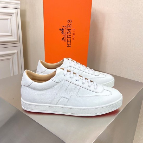 Hermes Boomerang White Leather Trainers Pair Front View Pair of Hermes Boomerang white leather low-top trainers standing together in front of the orange box.