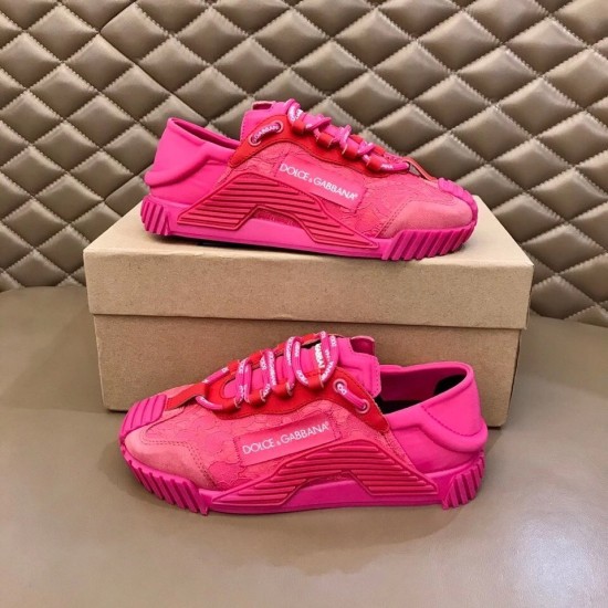 Two Dolce & Gabbana fuchsia pink lace trainers presented on and beside a box