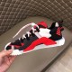 Dolce & Gabbana Red Trainer Outer Side Profile Hand holding Dolce & Gabbana red fabric trainer showcasing outer side details