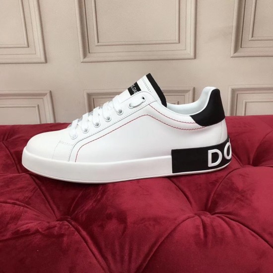 Profile view of Dolce & Gabbana Portofino white trainer on red surface