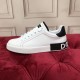 Profile view of Dolce & Gabbana Portofino white trainer on red surface