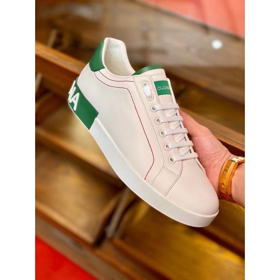 Dolce & Gabbana Portofino White Trainer Handheld View in white and green Handholding single white leather Portofino trainer showing side panel and green accents