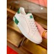 Dolce & Gabbana Portofino White Trainer Handheld View in white and green Handholding single white leather Portofino trainer showing side panel and green accents