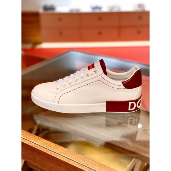Profile view of single Dolce & Gabbana Portofino white leather trainer with red accents