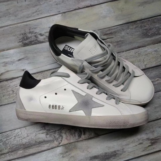 Golden Goose Super-Star White Trainer - Side Profile in white and grey Side profile of Golden Goose Super-Star white trainer showing metallic GGDB lettering and grey star
